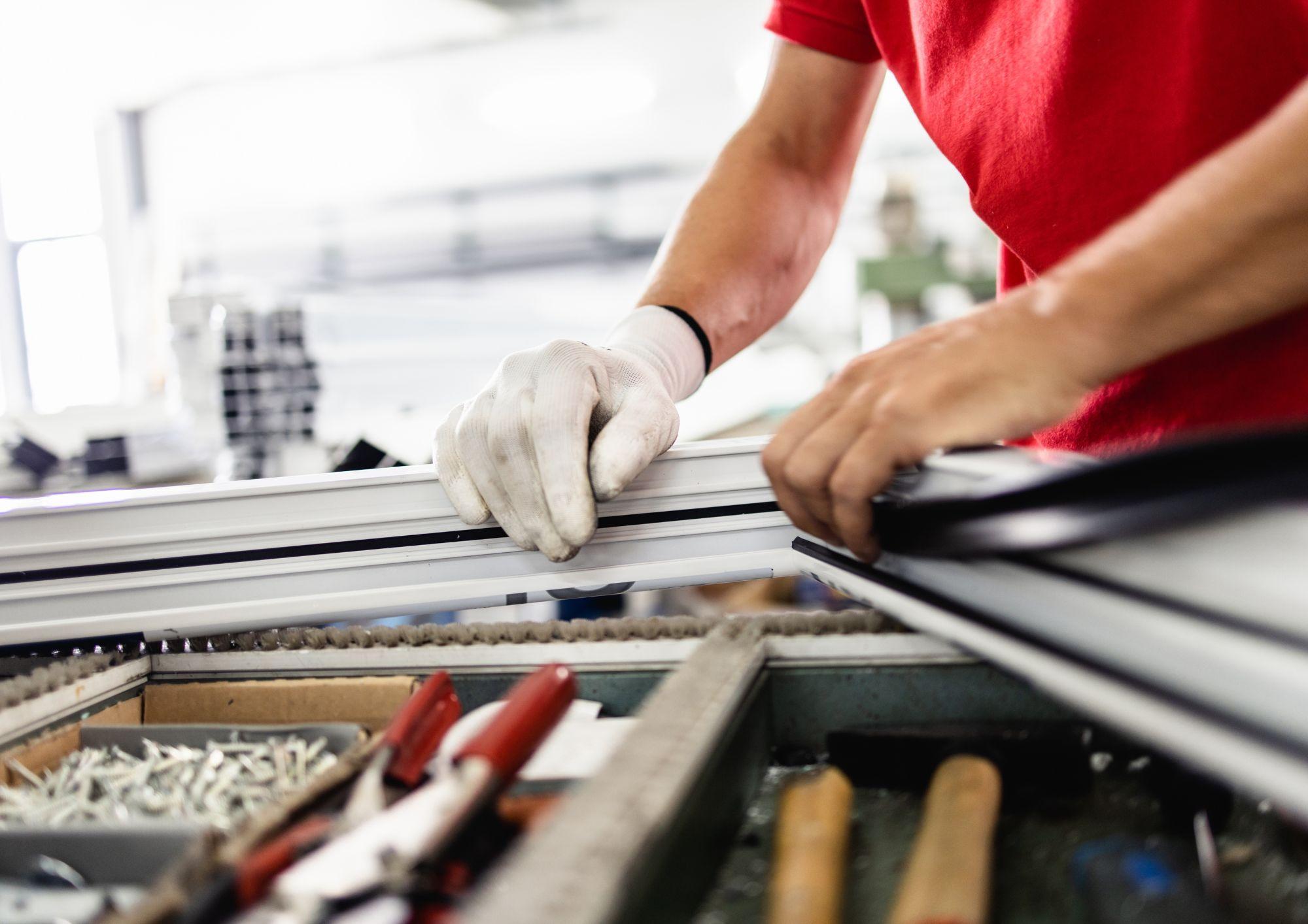Trabajador experto reparando y fabricando ventana a medida